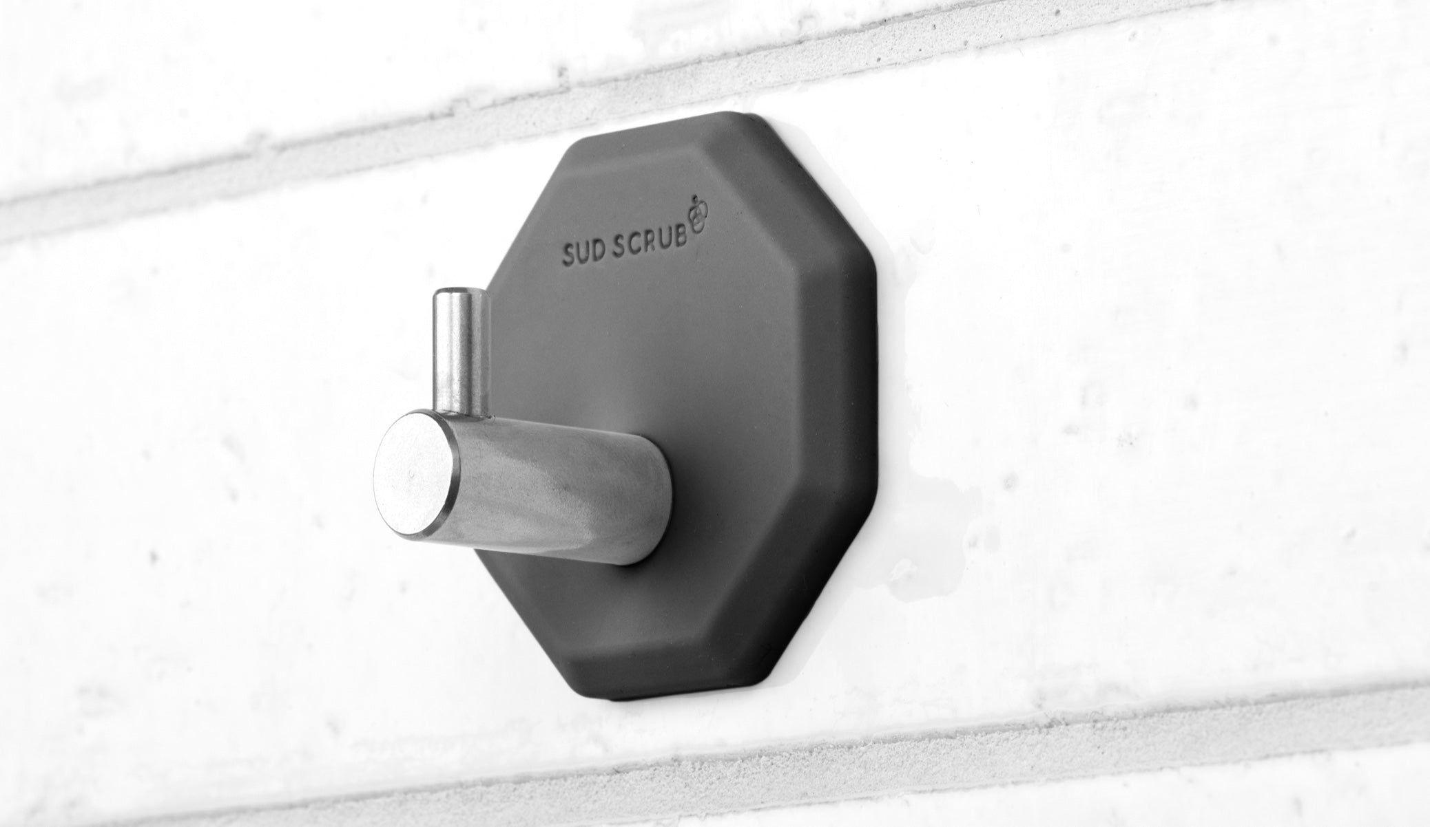 Up close detailed shot of the Charcoal Sud Scrub Shower Hook.