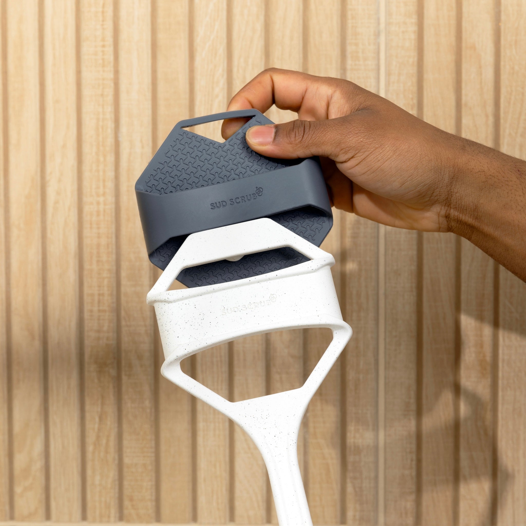 hand fastening Charcoal Sud Scrub Body Scrubber to Sud Scrub Extender Handle.
