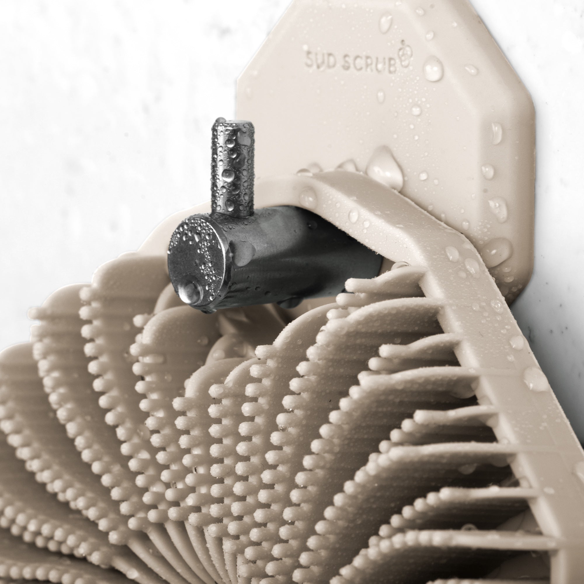 Up close detailed shot of Clay Sud Scrub Body Scrubber hanging on the Clay Sud Scrub Shower Hook in the shower.